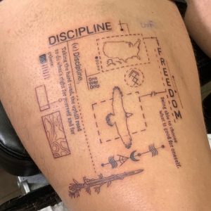 Design style tattoo with elements highlighting the words "Discipline" and "Freedom"